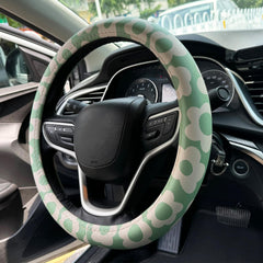 Naxizo Vintage Groovy Flowers steering wheel cover on wheel for enhanced grip and style on 15-inch rims.