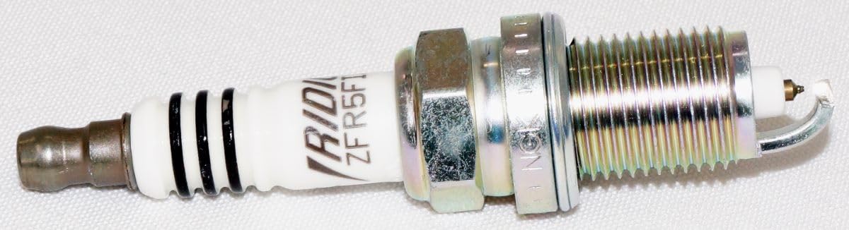 NGK 2477 iridium spark plug threads detail highlighting precision engineering.