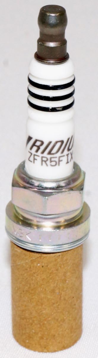 NGK 2477 spark plug installed in engine bay for quick installation reference.