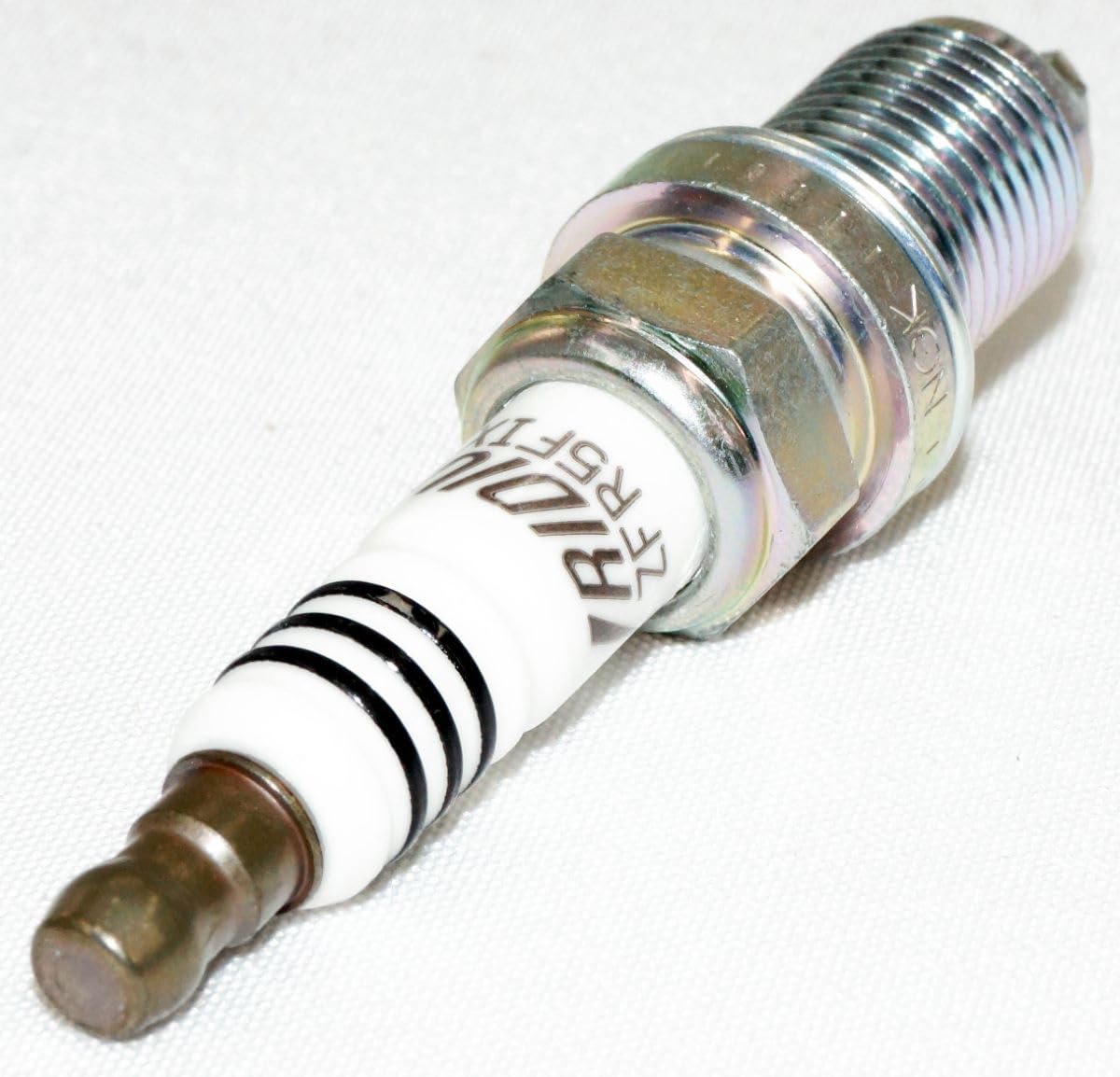 NGK 2477 spark plug packaging label showing four-pack value.