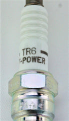 NGK 4177 TR6 V-Power spark plug shown on engine surface