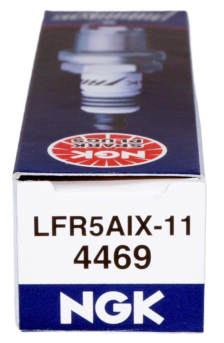 NGK 4469 Iridium IX spark plug next to a performance intake manifold.