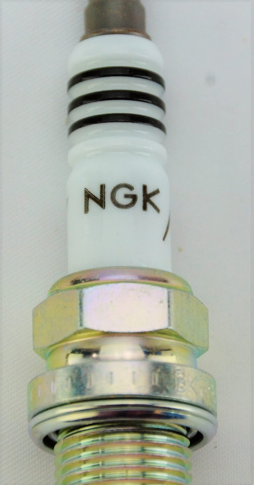 NGK Iridium IX 6418 plug design visible, emphasizing center electrode for efficient combustion.