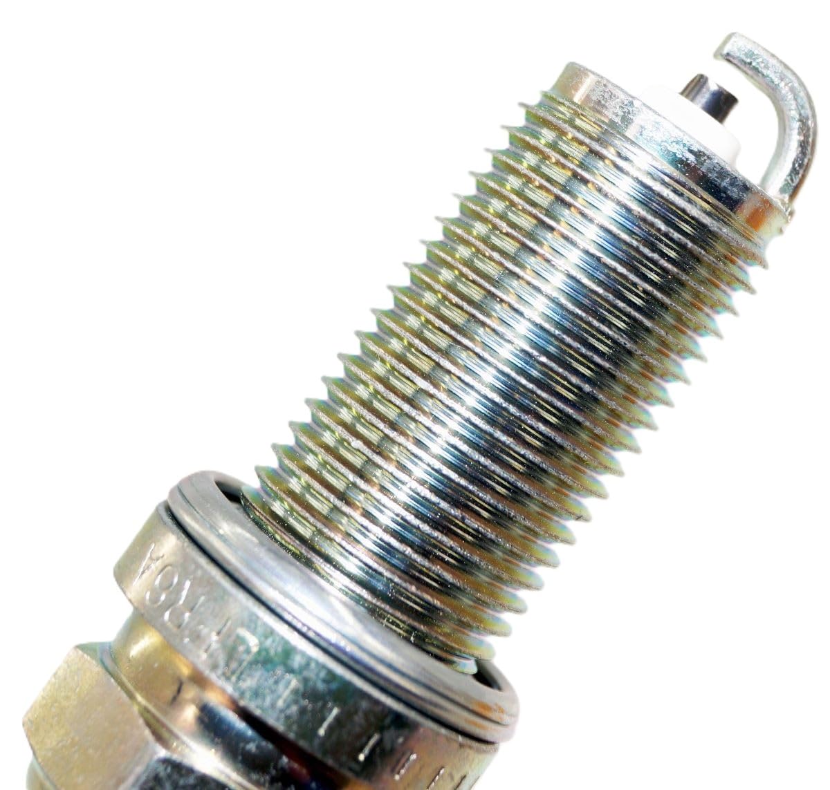 NGK LFR6A-11 spark plug in engine cylinder head view.