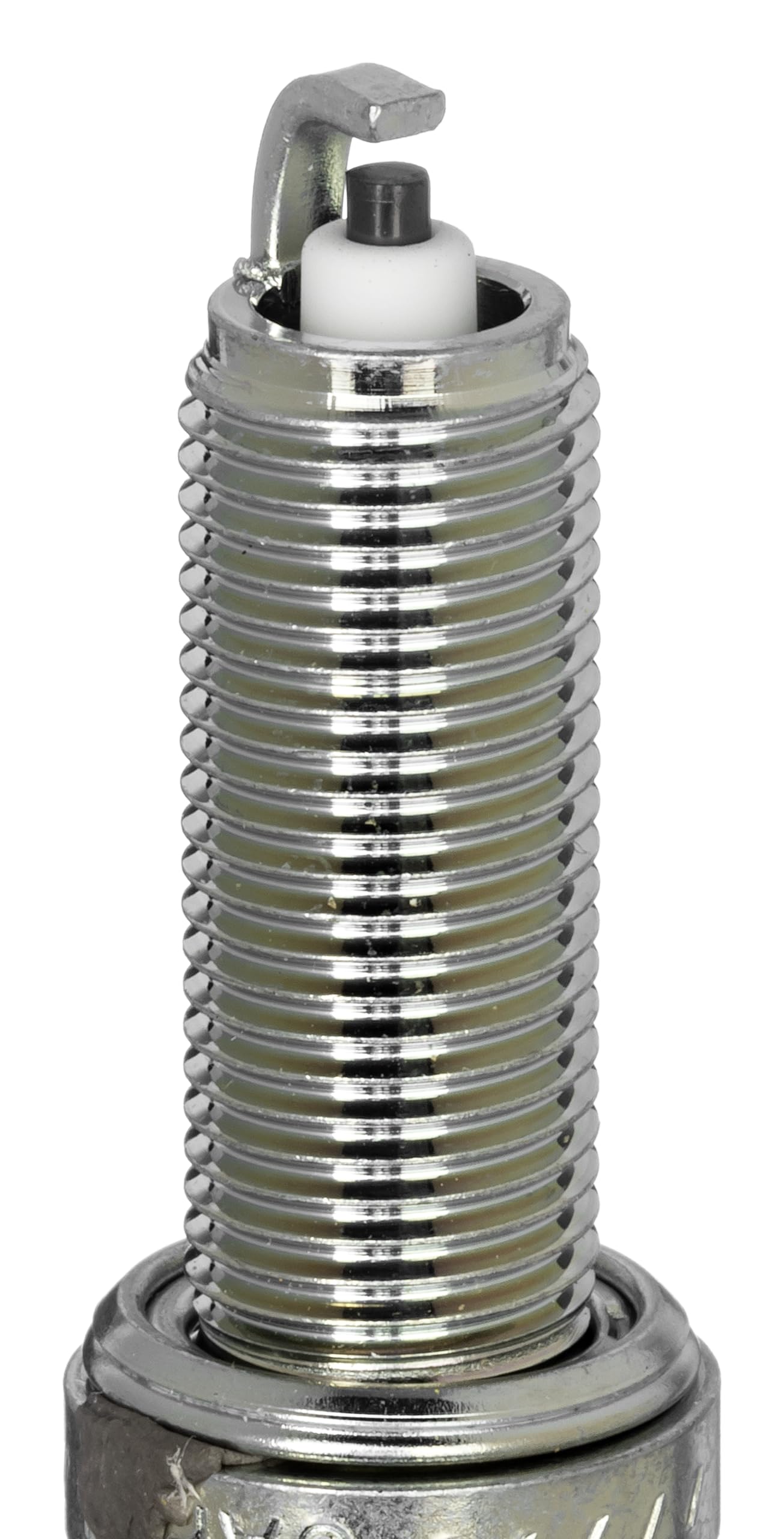 NGK LMAR7A-9 spark plug closeup shows corrugated insulator ribs for flashover prevention.