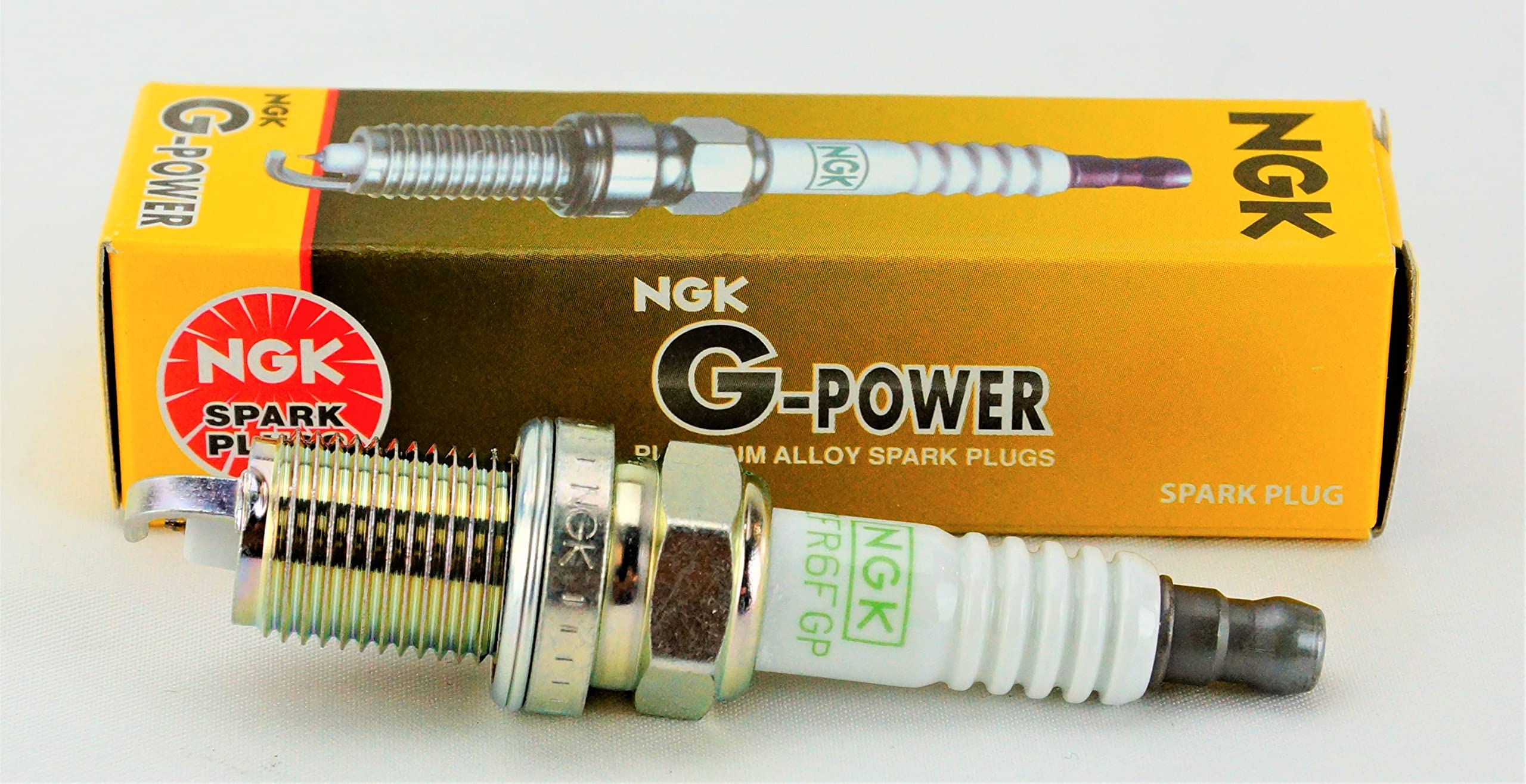 NGK spark plug 7100 ZFR6FGP with original packaging highlights authentic parts