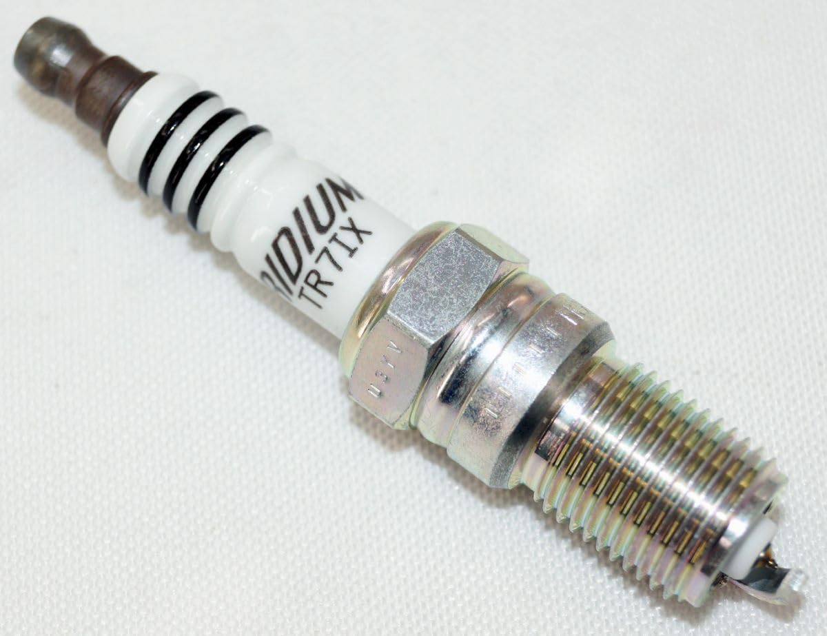 NGK spark plug installed in engine bay for smooth ignition potential