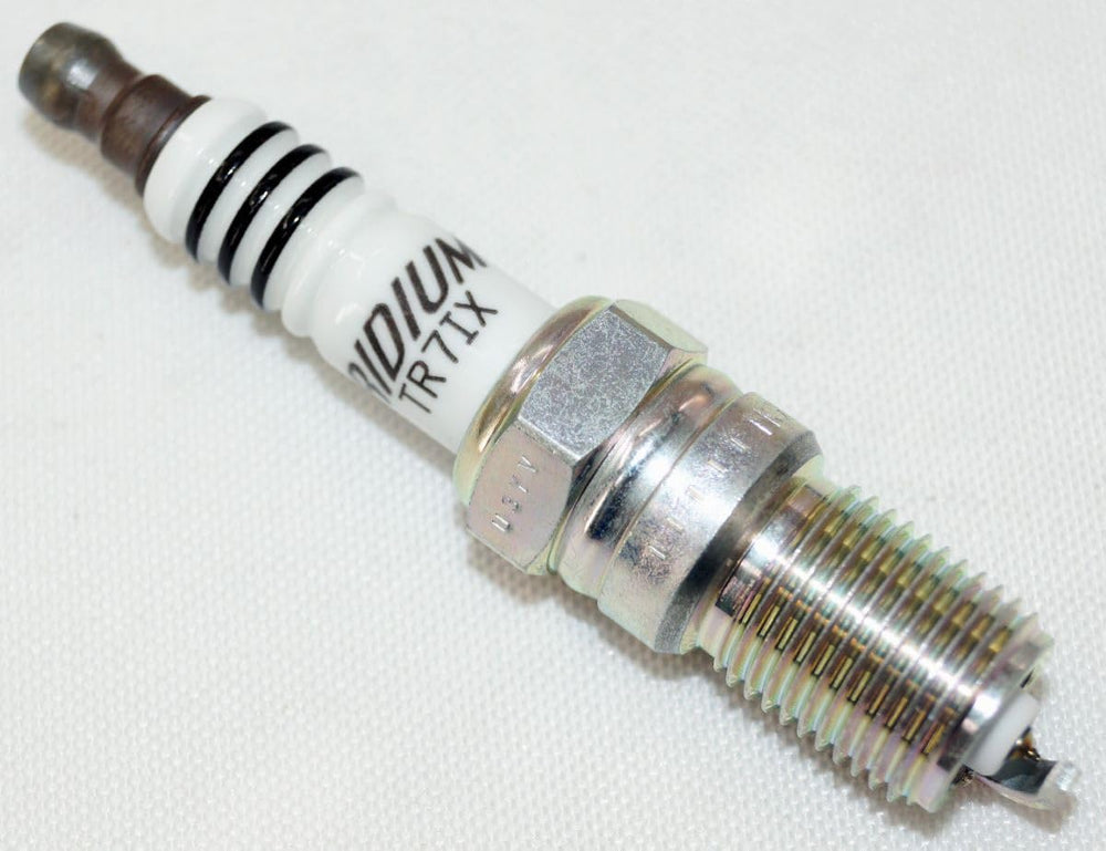 NGK spark plug installed in engine bay for smooth ignition potential