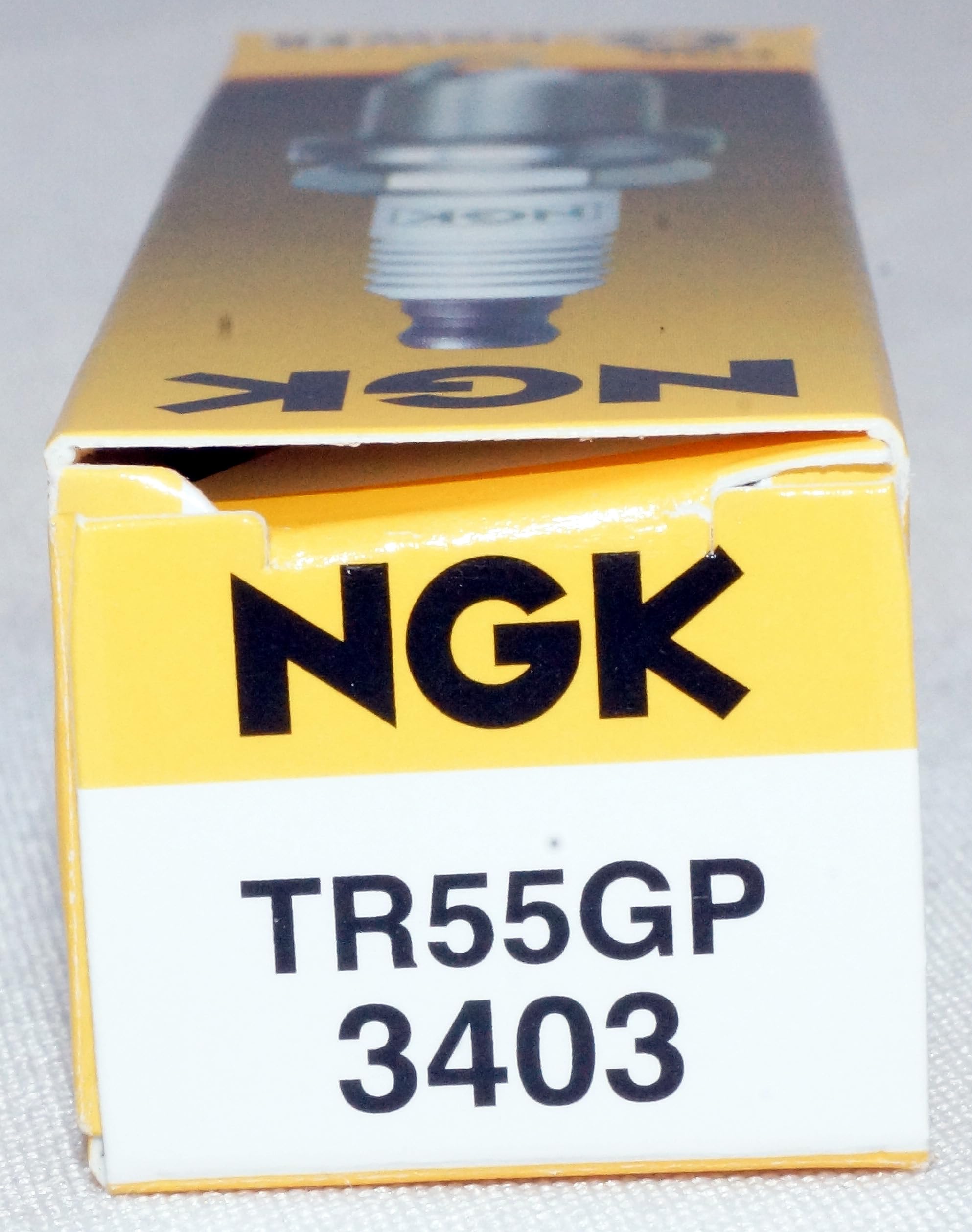 NGK TR55GP ceramic insulator and electrode close-up highlighting heat tolerance.
