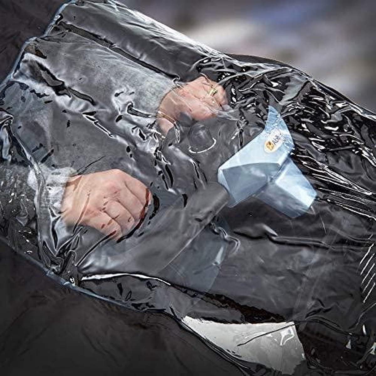 Nomiou rain cover material close-up shows PVC-coated fabric and lightweight feel.