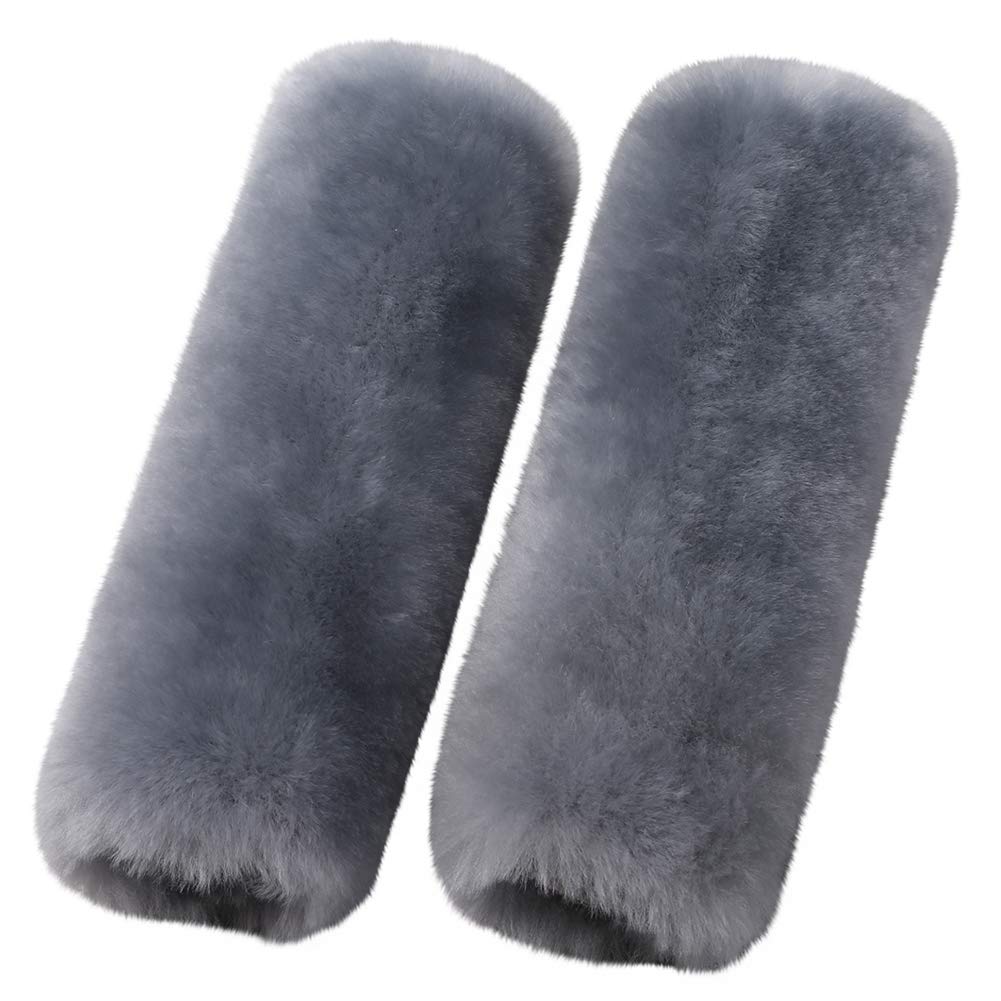 OGLAND merino wool seatbelt pad in blue gray resting on car seat with soft texture.
