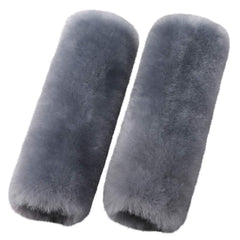 OGLAND merino wool seatbelt pad in blue gray resting on car seat with soft texture.