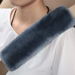 OGLAND seatbelt pad blue gray shown on strap highlighting plush comfort.