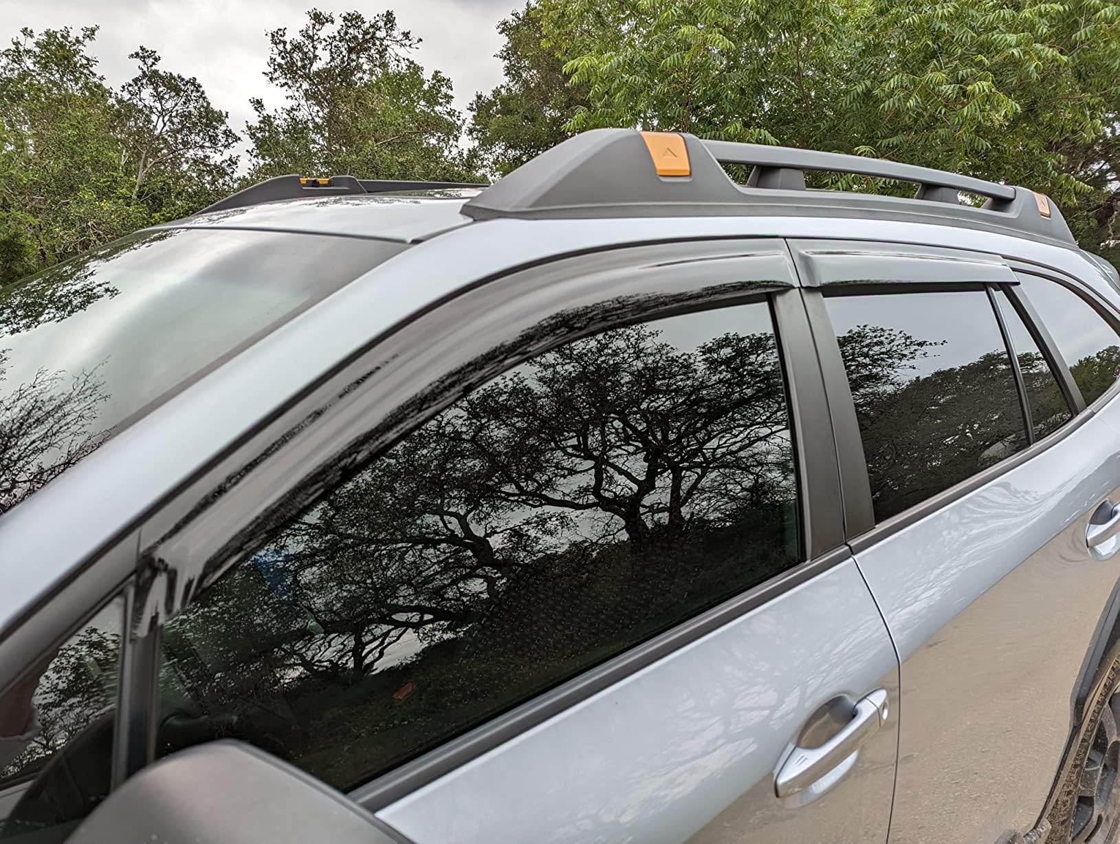 Olltoz Outback visor dark tint enhances glare reduction and sleek look on the window.