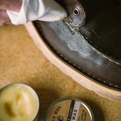 Otter Wax Boot Wax being applied on rugged leather boots.