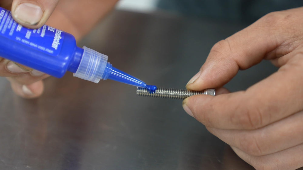 Permatex 24240 medium-strength threadlocker in use on a bolt.
