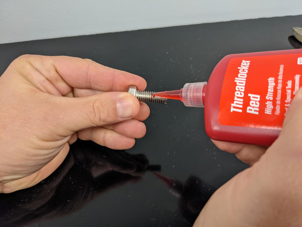Permatex 27140 threadlocker applied to a stud to prevent loosening