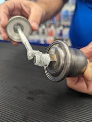 Permatex 80633 thread sealant being applied to fittings for a reliable seal.