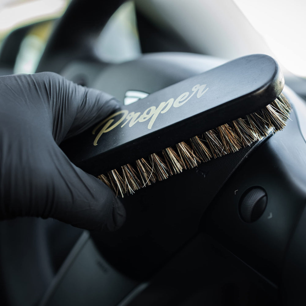 PROPER DETAILING CO. car seat brush in action cleans seams effectively