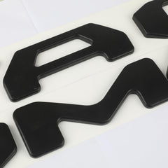 Pukonger tailgate logo close-up 3D effect emphasizes refined detail and weather resistance.