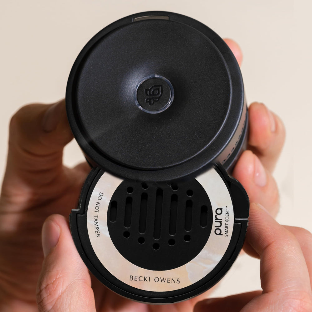 Pura car diffuser app control demonstrates easy scent management on smartphone.