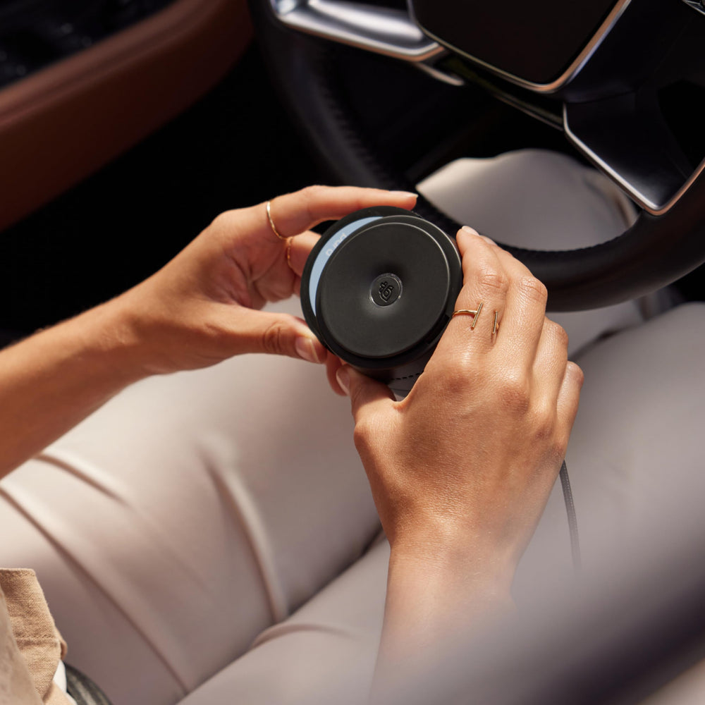 Pura Homesick diffuser shown with app control on smartphone screen.