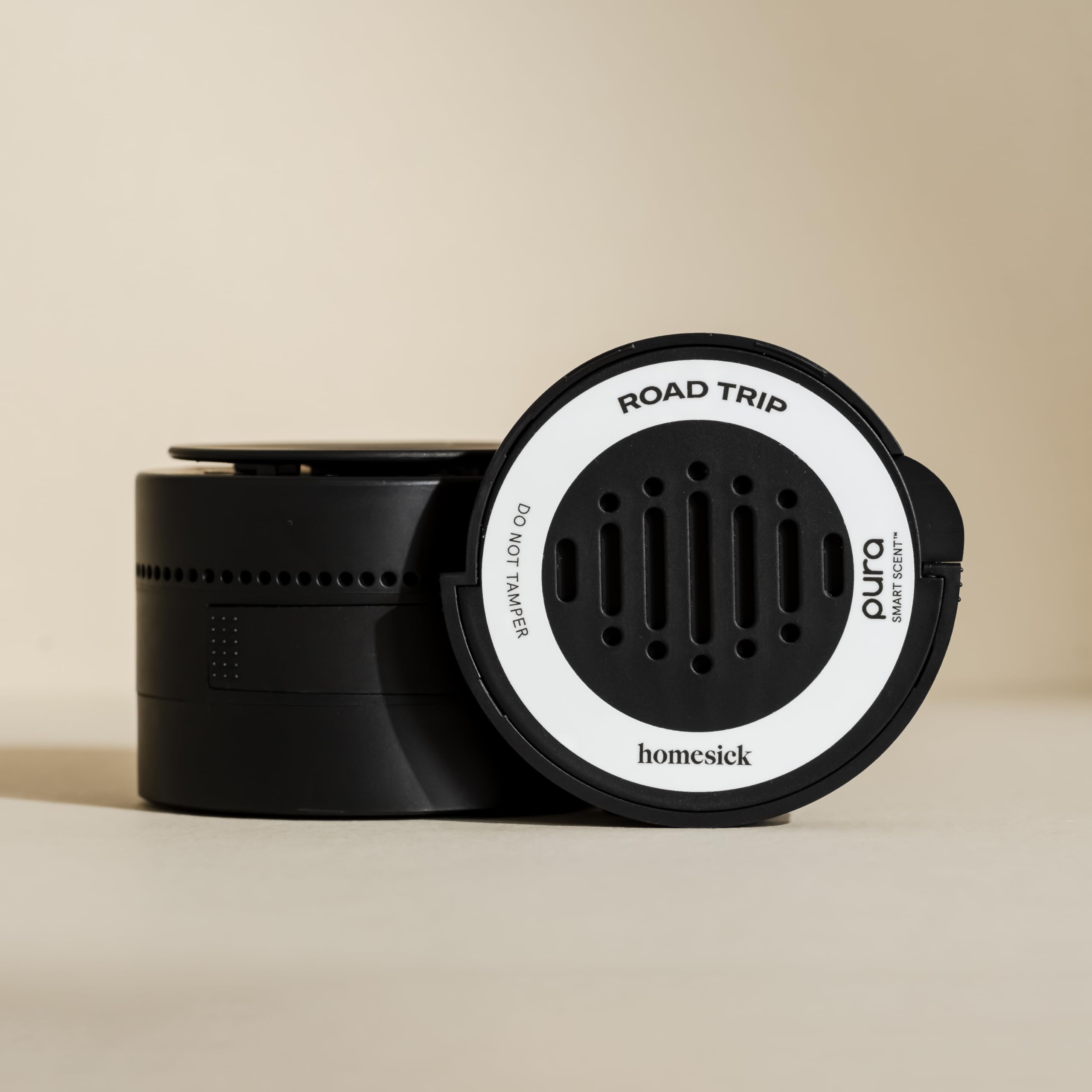 Pura Homesick car diffuser mounted on dashboard for hands-free fragrance.