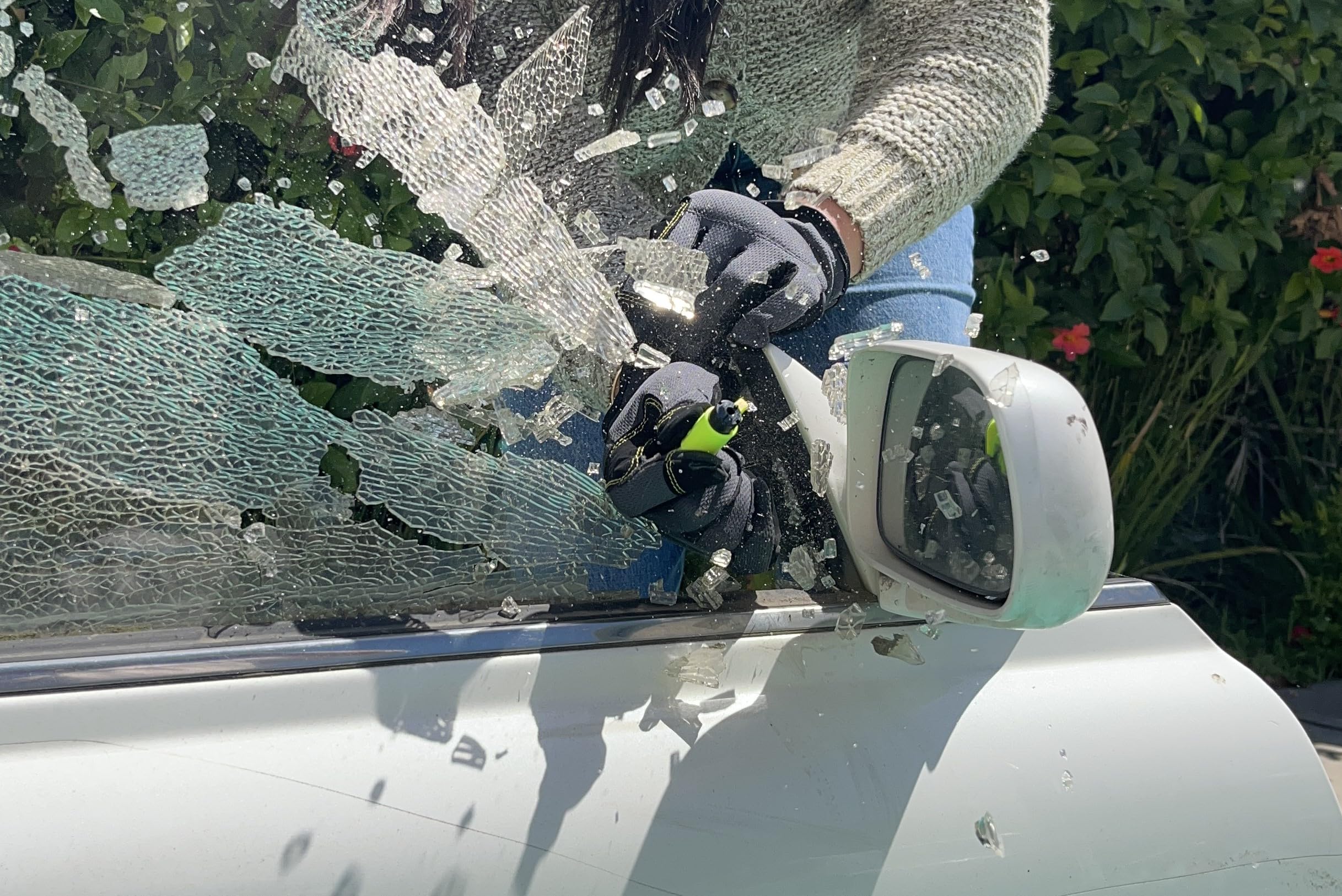 RESQME window breaker in action shows tempered glass break for quick exit.