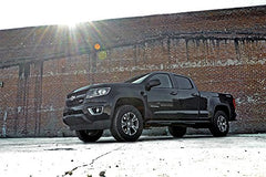 Rough Country 2in Leveling Kit rear spacer with factory wheels demonstrating level stance