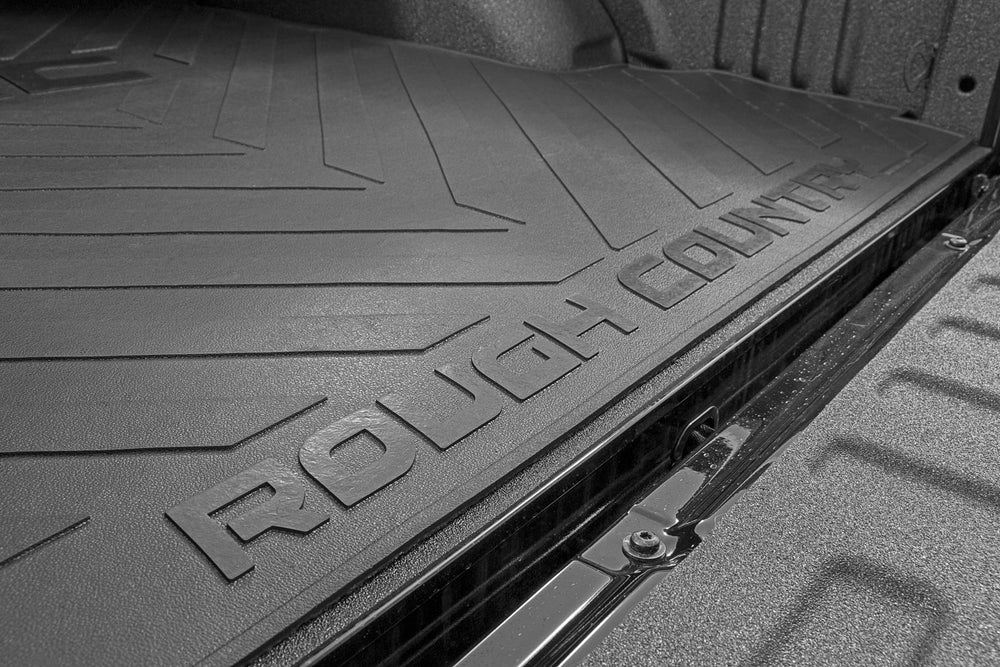 Rough Country rubber bed mat rolled out illustrates quick drop-in installation.