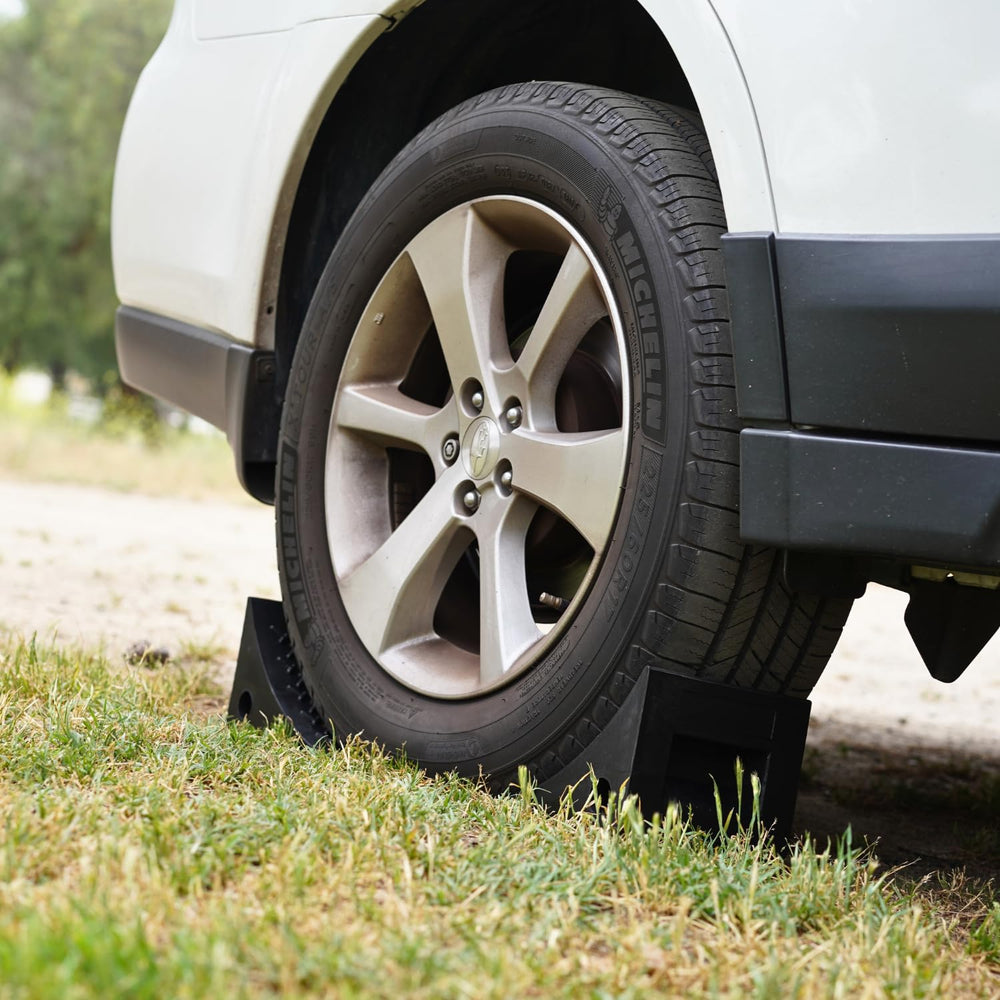 SECURITYMAN durable black rubber wheel chocks for outdoor use.