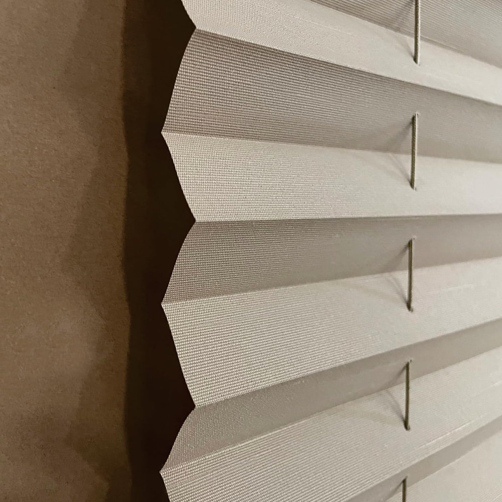 Close-up of soft pleated fabric in cappuccino shade.