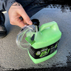 Pouring Slime sealant into a tire to seal a puncture