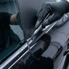 Spanno plastic scraper for tight edges and bubble removal.