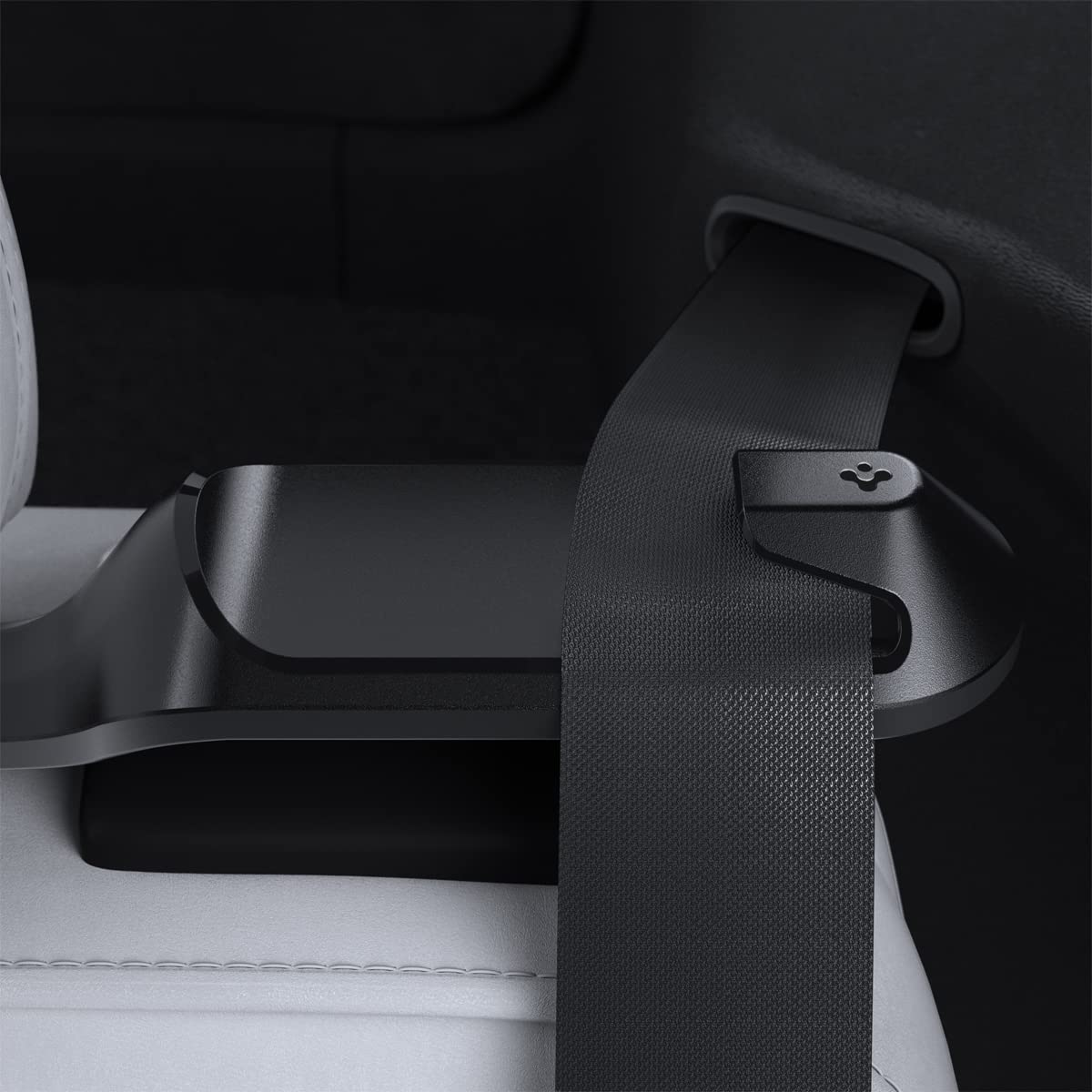 Spigen backseat belt guide holder installed in a Tesla Model Y for neat belt management.