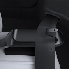 Spigen backseat belt guide holder installed in a Tesla Model Y for neat belt management.