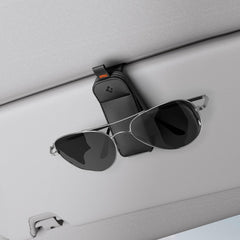 Spigen magnetic vegan leather sunglasses holder for car sun visor provides secure quick access.
