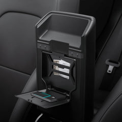 Spigen One-Tap Hidden Storage Box for Tesla Model Y Juniper installs under the armrest for secure storage.