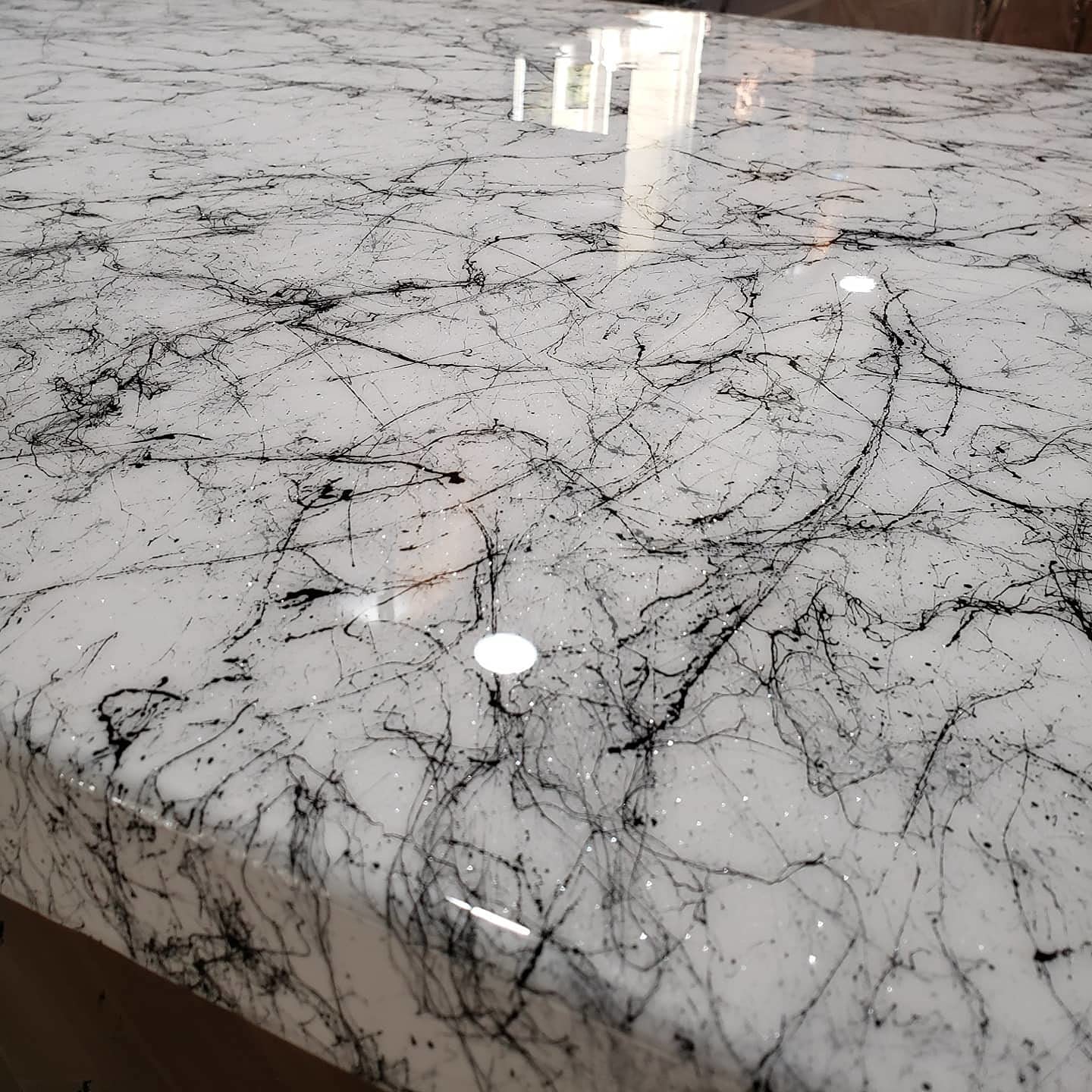 Stone Coat Countertops crystal-clear polish applied to a glossy epoxy finish