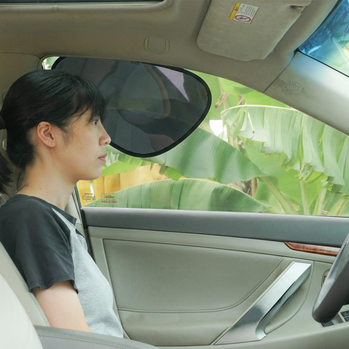 TFY car side window sun shade on left window blocking glare and reducing heat.
