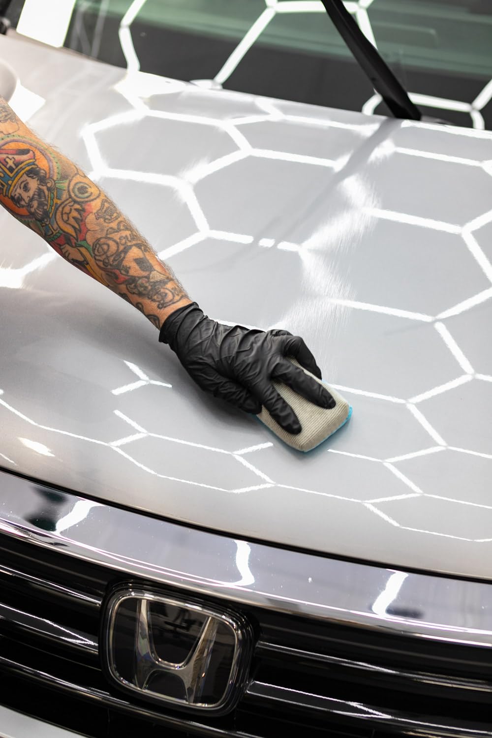 Close-up The Rag Company coating tools in a detailing setup