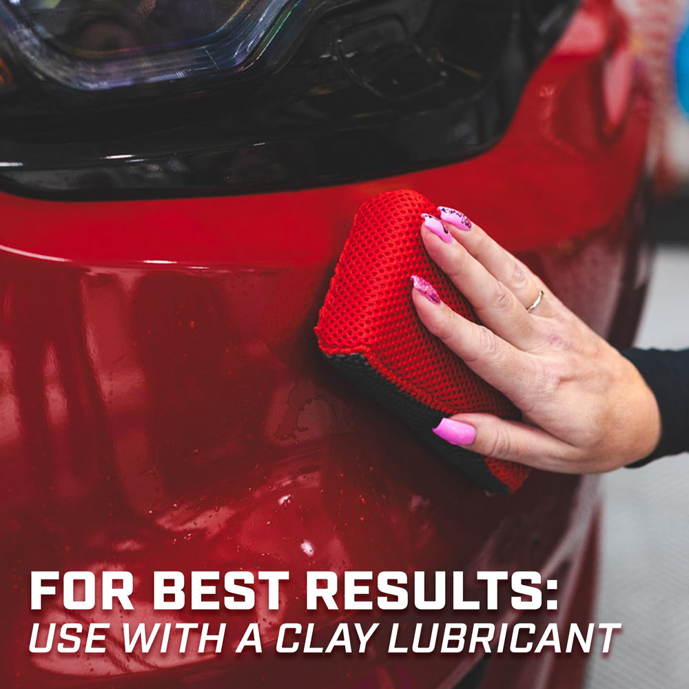 The Rag Company Reset Clay Scrubber 2-pack rests in a wet bucket for reuse.