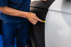 The Wrap Institute green 90-degree edge close-up helps prying rubber and tucking behind edges.