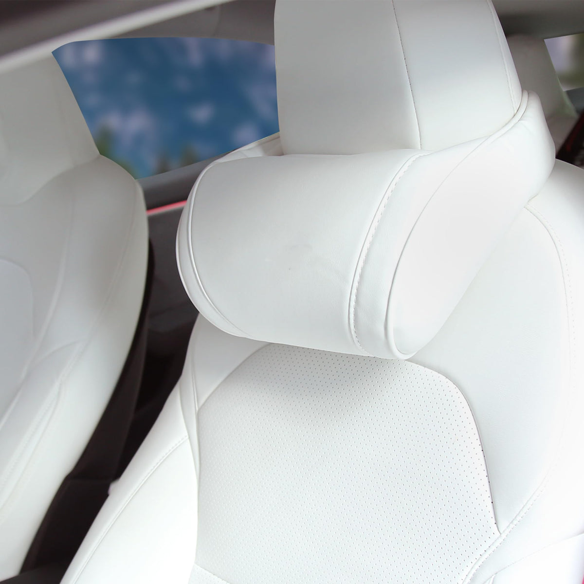TOPABYTE neck pillow fitted on a Tesla headrest for comfortable driving.