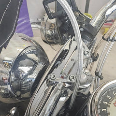 Chrome top clamp close-up showing durable CNC aluminum construction for Harley touring bikes.