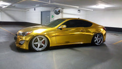 VViViD Gold Mirror Chrome vinyl being applied with bubble-free air release for a smooth finish.
