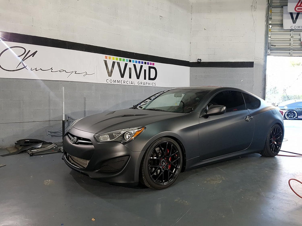 VVIVID+ matte metallic black wrap on curved panel showing seamless fit