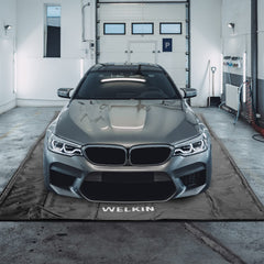 Welkin Containment Mat 7-9x16 protecting garage floor from spills and stains.