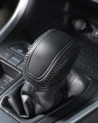 Close interior detail of YAKANEY leather gear shift cover in black