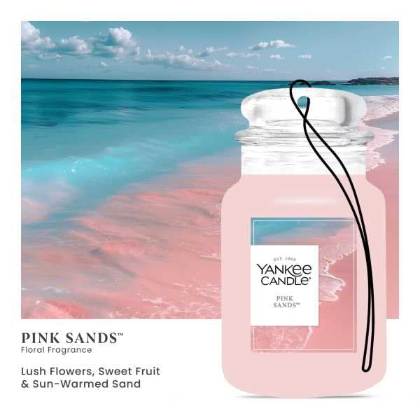 Yankee Candle Car Jar Pink Sands hanging from the rearview mirror for easy refreshment